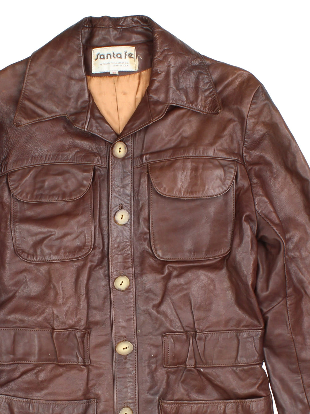 Vintage Santa Fe Leather Trench Coat in a brown colourway. Button up with wood sytle detailing and multiple pockets on the front.