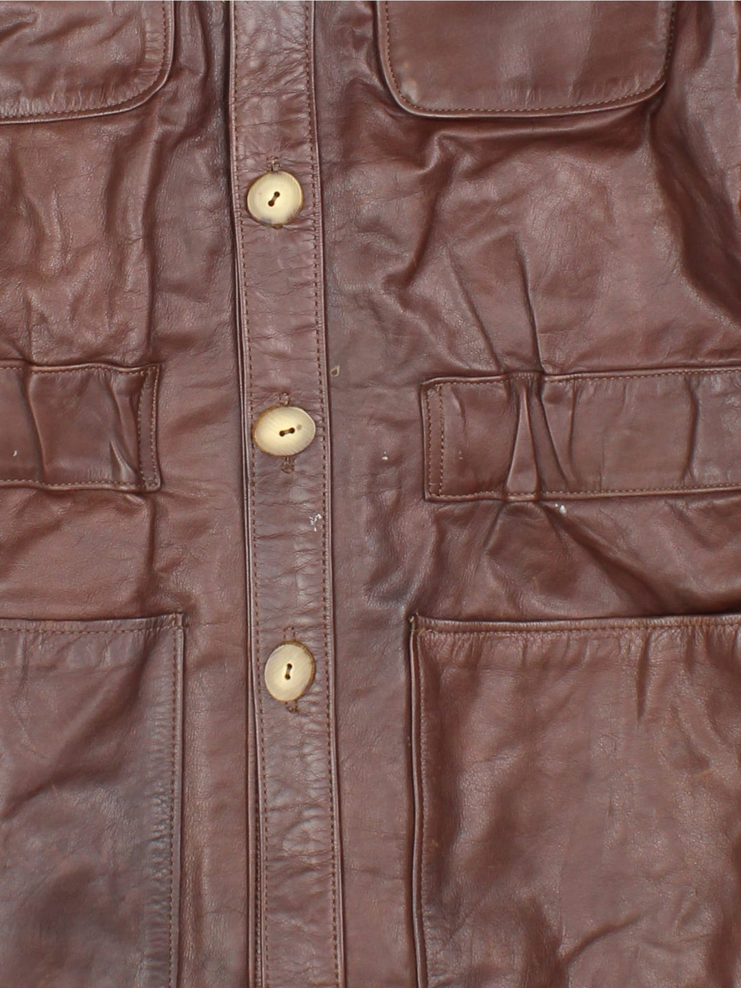 Vintage Santa Fe Leather Trench Coat in a brown colourway. Button up with wood sytle detailing and multiple pockets on the front.