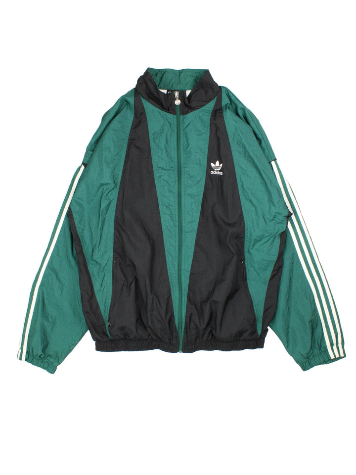 Vintage 90's Adidas Tracksuit Jacket in a green and black patterned colourway. Zips up and has side pockets, and the logo embroidered on the front.