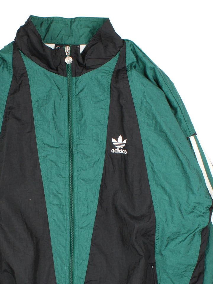 Vintage 90's Adidas Tracksuit Jacket in a green and black patterned colourway. Zips up and has side pockets, and the logo embroidered on the front.