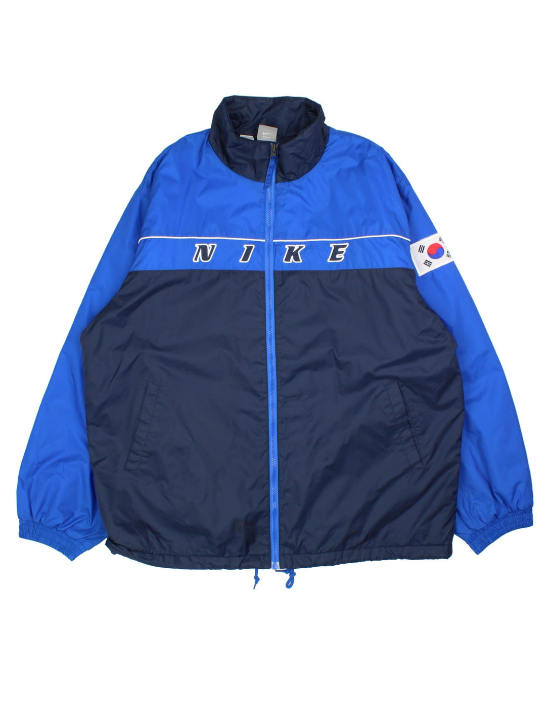 Vintage Nike Korea Coach Jacket in a blue colourway. Zips up and has side pockets, insulated with a quilted lining, and the logo embroidered on the front and on the back Korea spell out with embroidered tiger graphic.