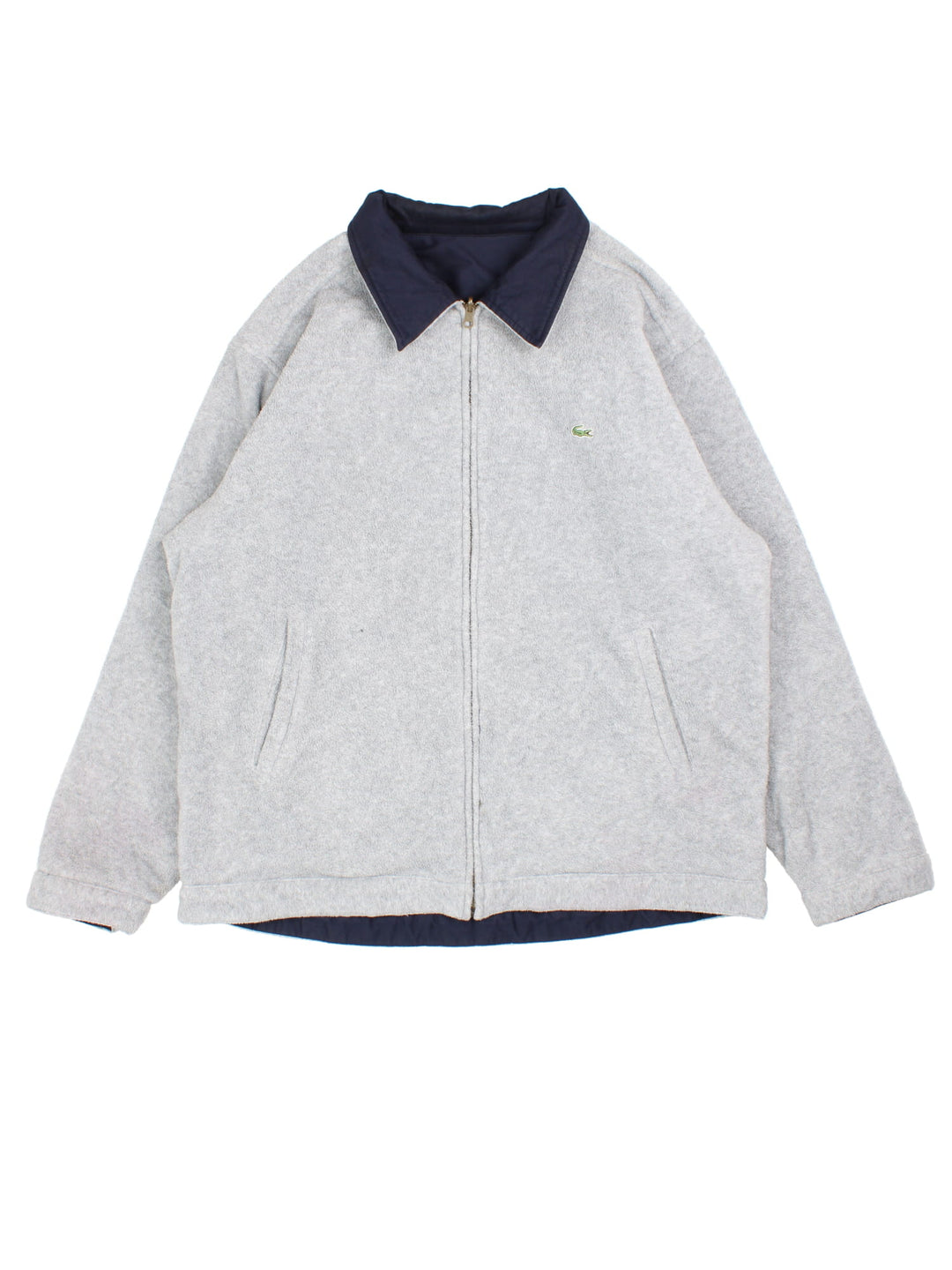 Lacoste Reversible Bomber Jacket in a blue and grey colourway with either jacket or fleece reversible options. Zips up and has side pockets, insulated lining, and has the logo embroidered on the front.