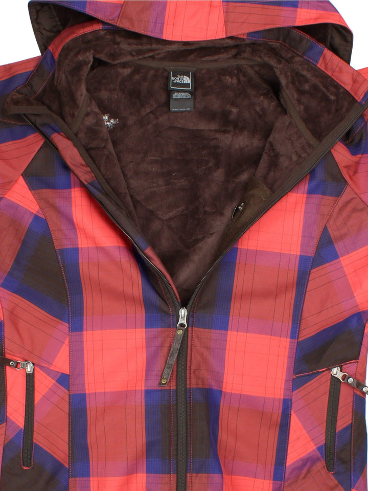 The North Face Plaid Jacket in a red, blue and black patterned colourway. Zips up and has side pockets, insulated with a fleece lining, hooded and has the logo embroidered on the front and back.