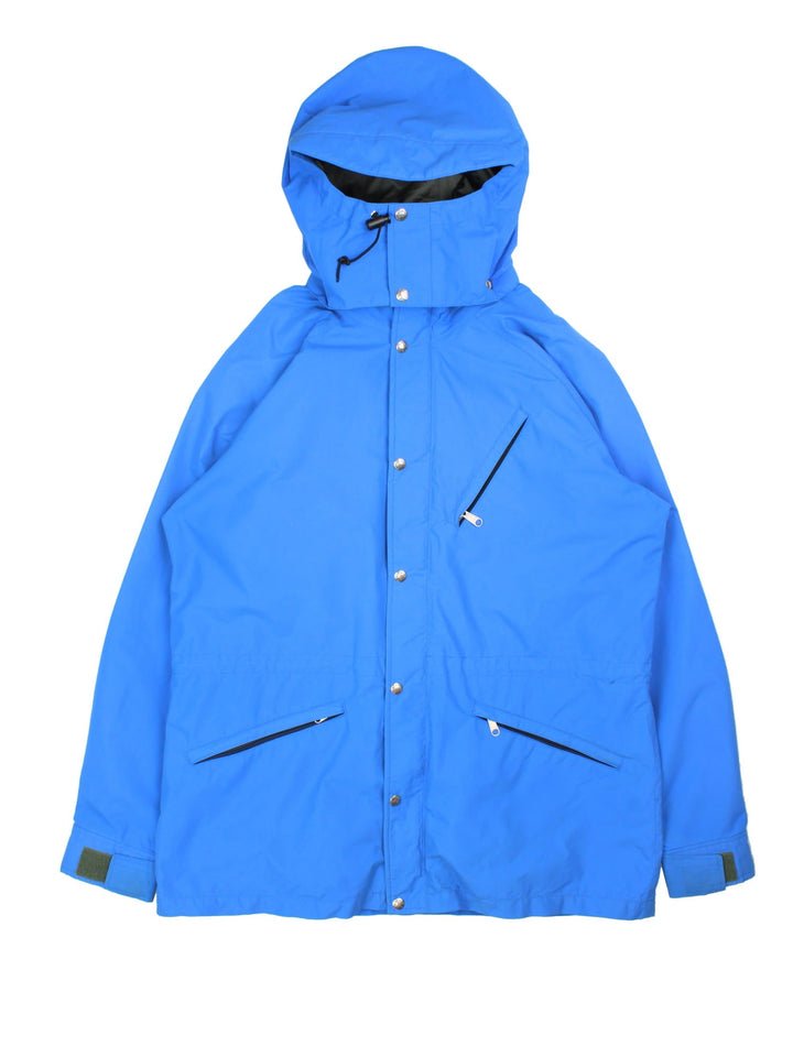 Vintage The North Face Gore-Tex Jacket in a blue colourway. Zips and buttons up, has multiple pockets, and a detachable hood.