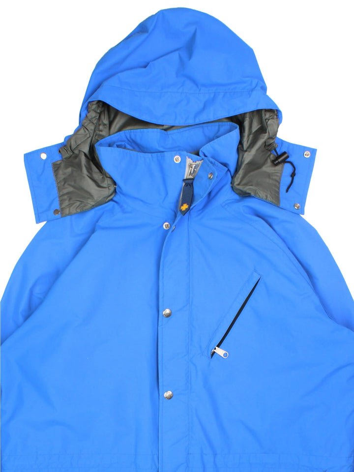 Vintage The North Face Gore-Tex Jacket in a blue colourway. Zips and buttons up, has multiple pockets, and a detachable hood.