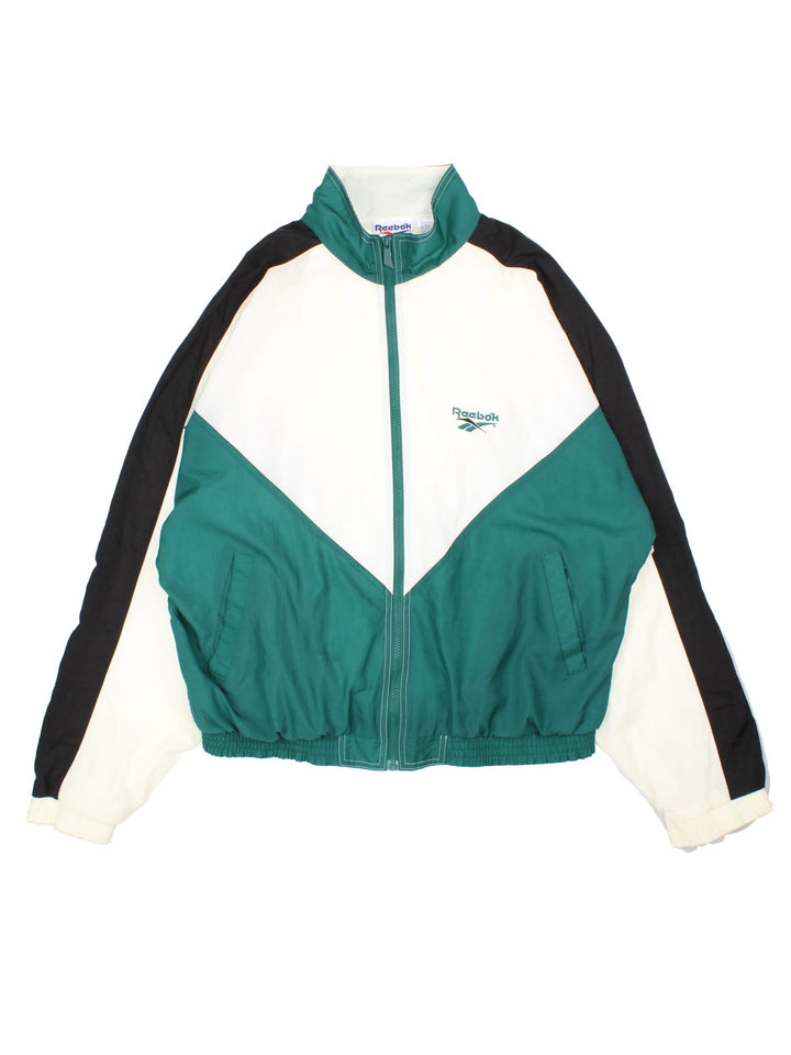 Vintage 90's Reebok Tracksuit Jacket in a white, green and black colourway. Zips up and has side pockets, and the logo embroidered on the front and back.