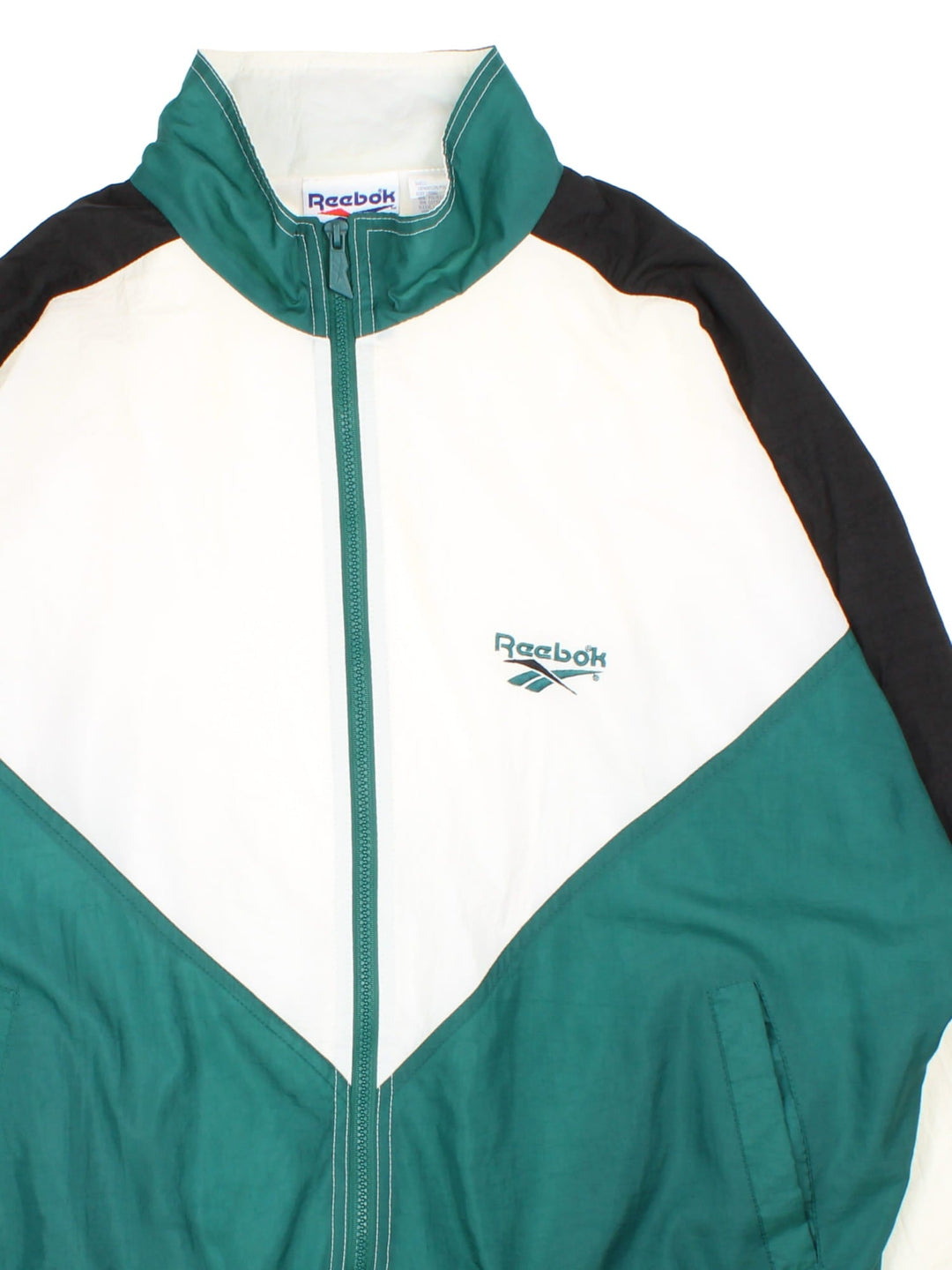 Vintage 90's Reebok Tracksuit Jacket in a white, green and black colourway. Zips up and has side pockets, and the logo embroidered on the front and back.