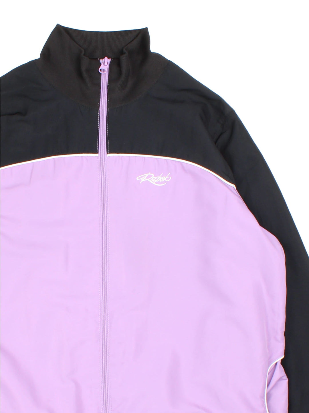 Vintage Reebok Tracksuit Jacket in a purple and black colourway. Zips up and has side pockets, and the logo embroidered on the front.