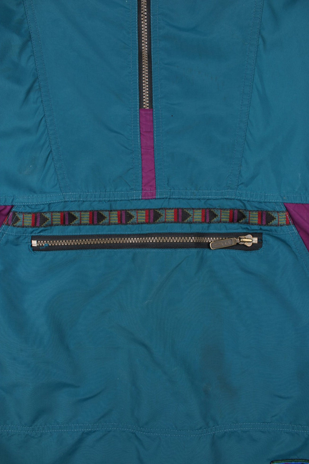 Vintage L.L Bean Lightweight Aztec Anorak Jacket in a blue, green and purple colourway. Half zips up and has pouch pockets, Aztec patterns embroidered on the front, hooded and has the logo embroidered on the front.