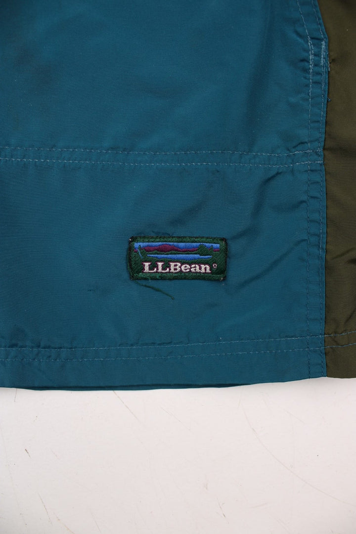 Vintage L.L Bean Lightweight Aztec Anorak Jacket in a blue, green and purple colourway. Half zips up and has pouch pockets, Aztec patterns embroidered on the front, hooded and has the logo embroidered on the front.