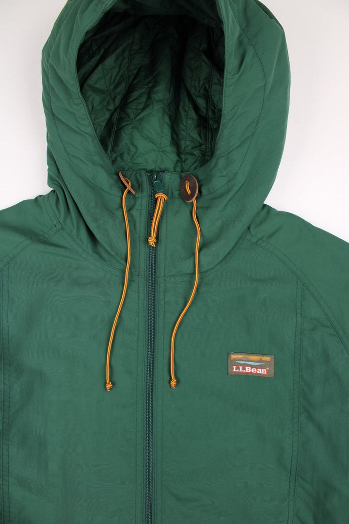 L.L Bean Mountain Classic Anorak Jacket in a green and blue colourway. Half zips up and has pouch pockets, insulated with a quilted lining, hooded, and has the logo embroidered on the front.