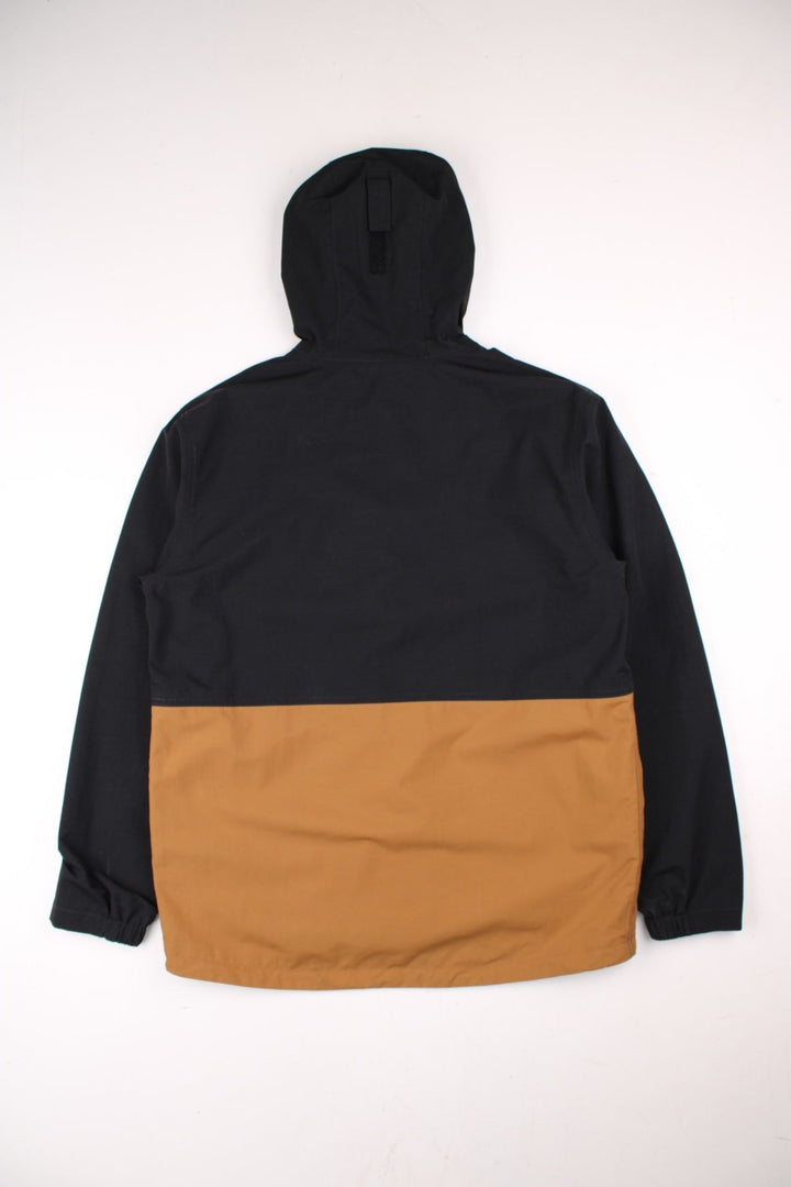 Carhartt Storm Defender Jacket in a black and brown colourway. Zips up and has multiple pockets, mesh lining, hooded and has the logo embroidered on the front.