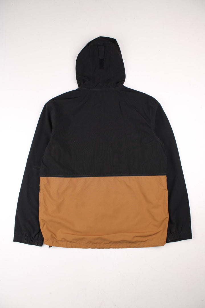 Carhartt Storm Defender Jacket in a black and brown colourway. Zips up and has multiple pockets, mesh lining, hooded and has the logo embroidered on the front.