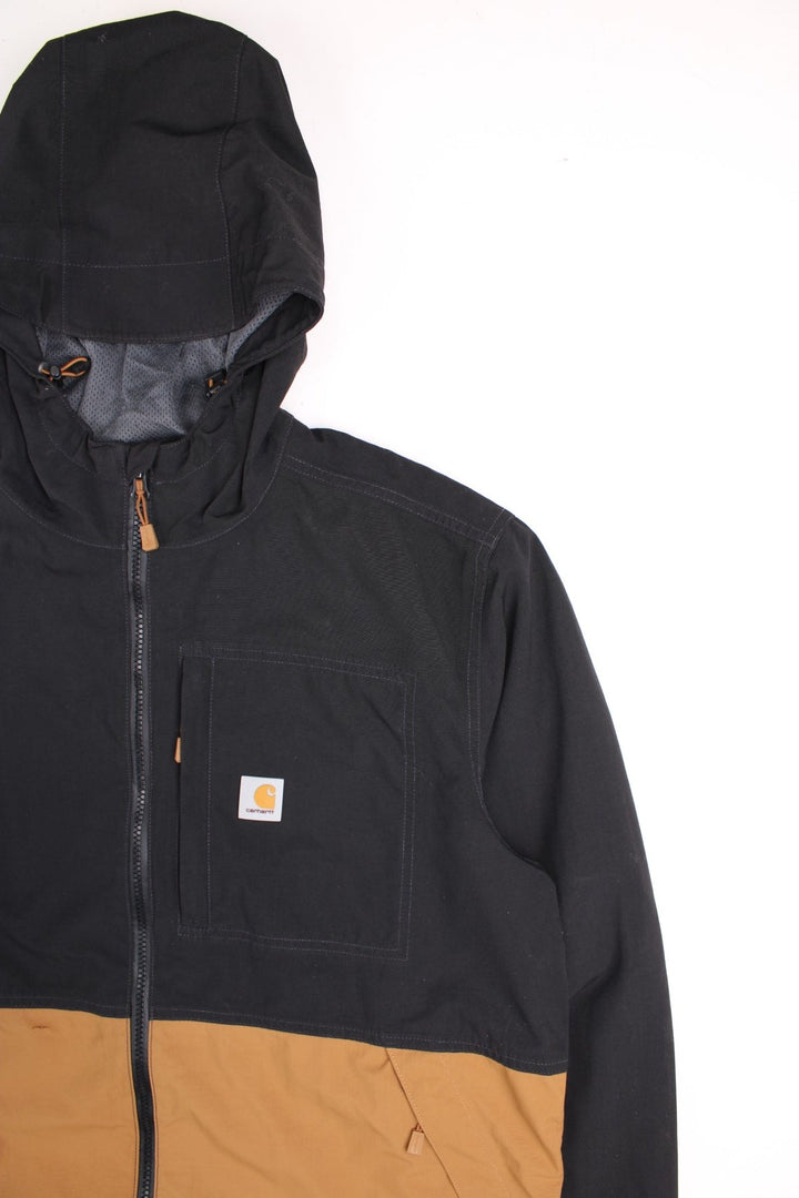 Carhartt Storm Defender Jacket in a black and brown colourway. Zips up and has multiple pockets, mesh lining, hooded and has the logo embroidered on the front.