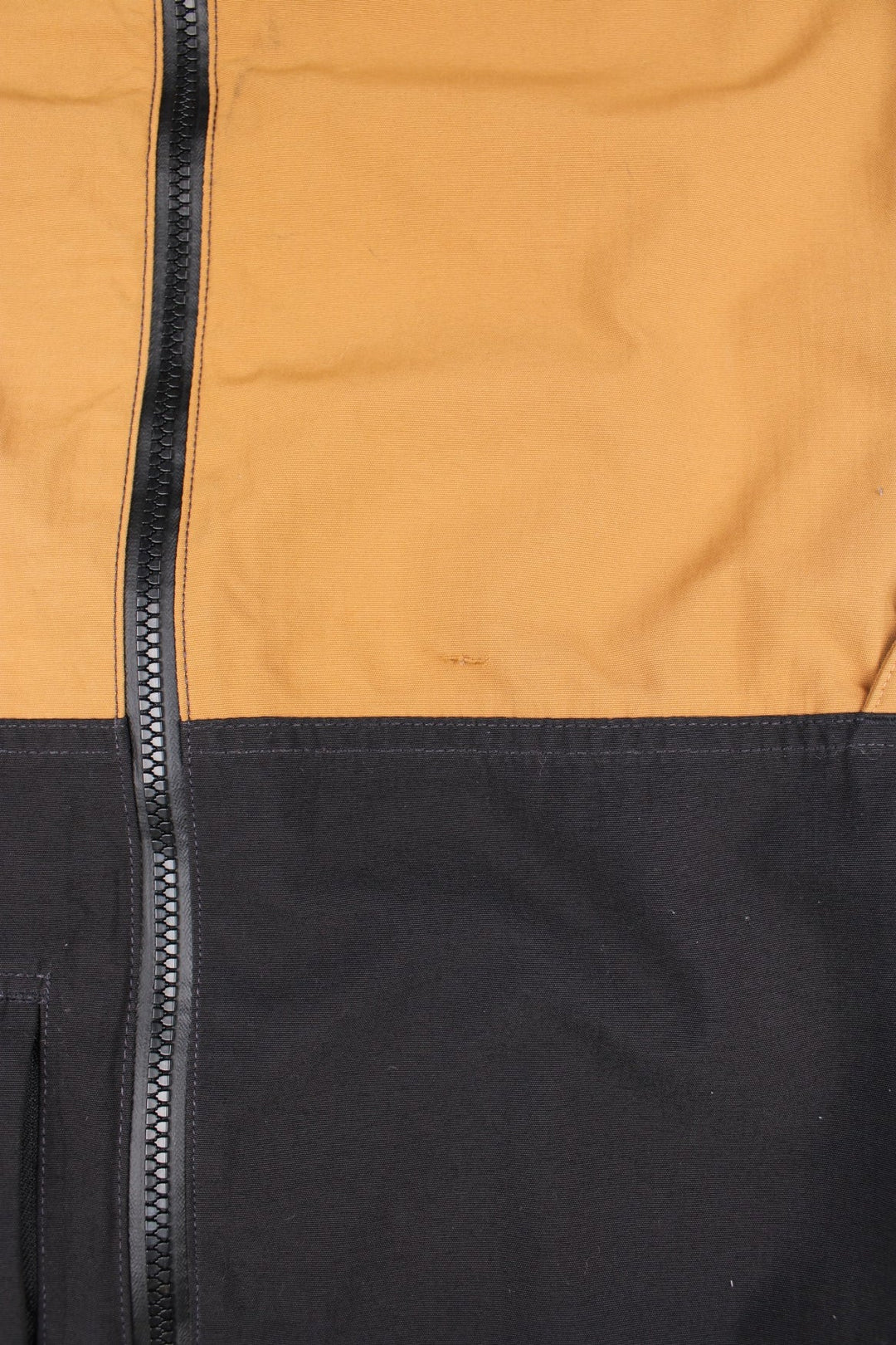 Carhartt Storm Defender Jacket in a black and brown colourway. Zips up and has multiple pockets, mesh lining, hooded and has the logo embroidered on the front.