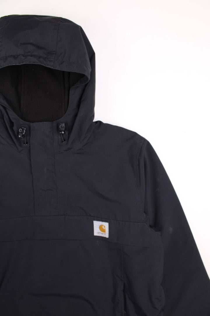 Carhartt Nimbus Pullover Jacket in a black colourway. Quarter zip up and has a pouch pocket, insulated with a fleece lining, hooded, and has the logo embroidered on the front.