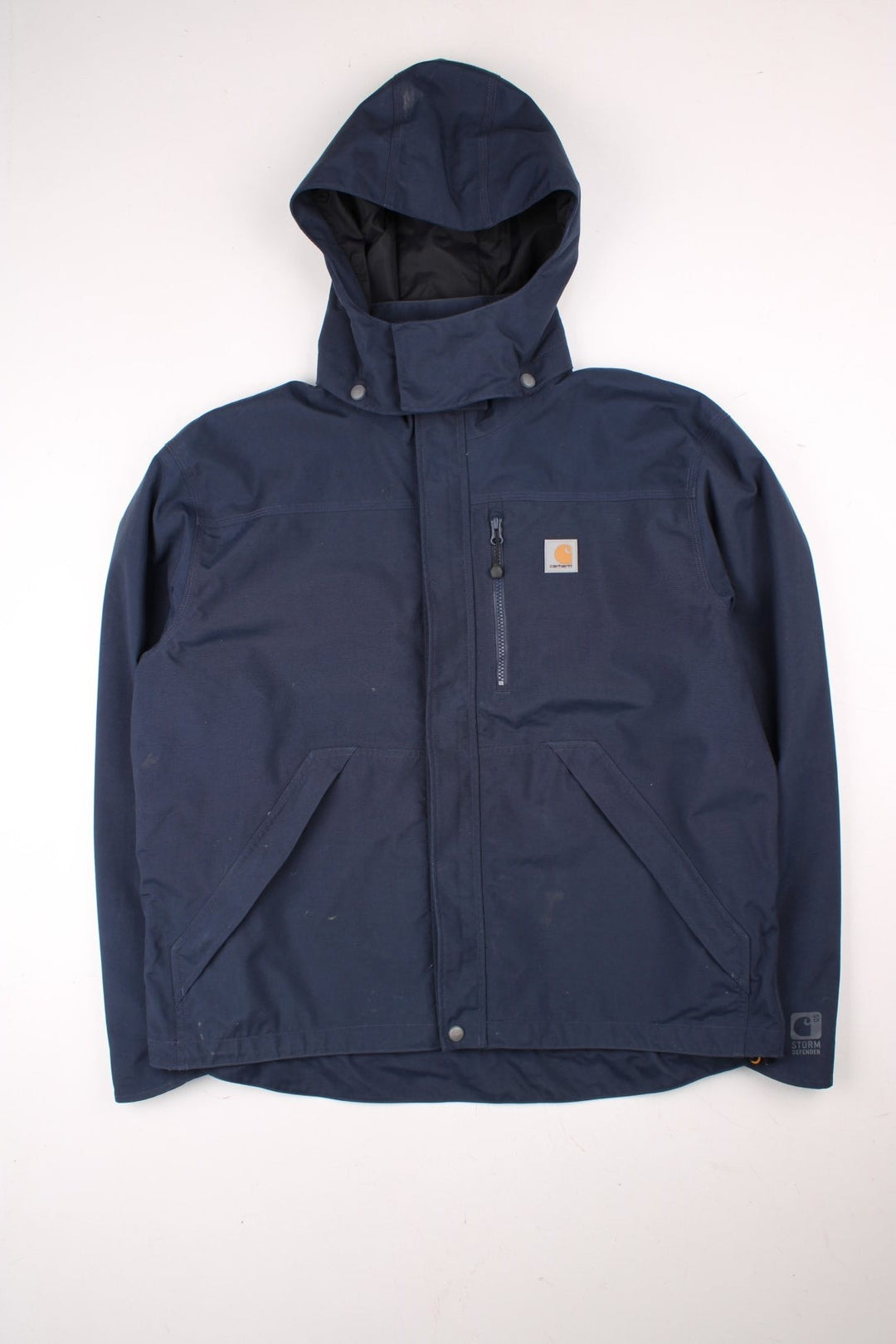 Carhartt Shoreline Jacket in a navy blue colourway. Zips up and has multiple pockets, detachable hood, mesh lining, and has the logo embroidered on the front.