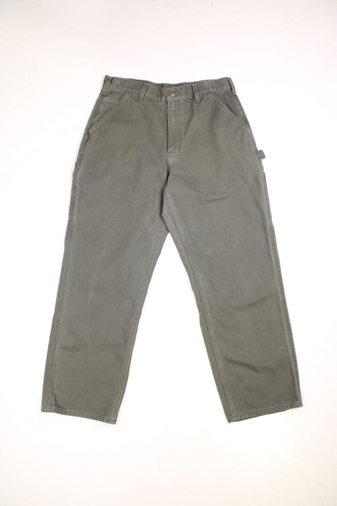 Carhartt carpenter jeans in green with multiple pockets and a logo patch on the back.