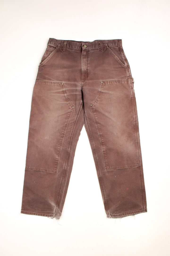 Carhartt Double Knee Jeans in a brown colourway, has multiple pockets and the logo embroidered on the back.