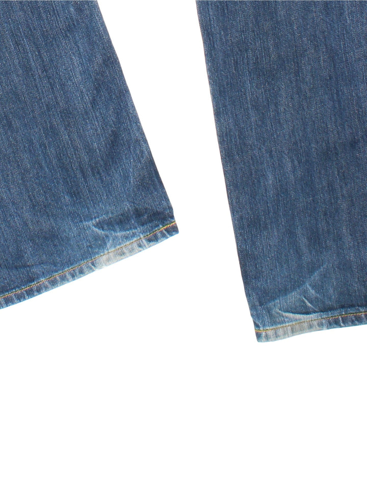 Levi Strauss 501 Jeans in med blue wash colourway with multiple pockets and the logo tab embroidered on the back.