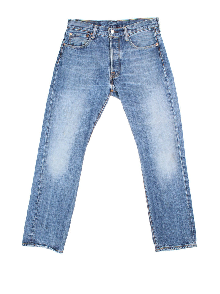 Levi Strauss 501 Jeans in blue colourway with multiple pockets and the logo tab embroidered on the back.