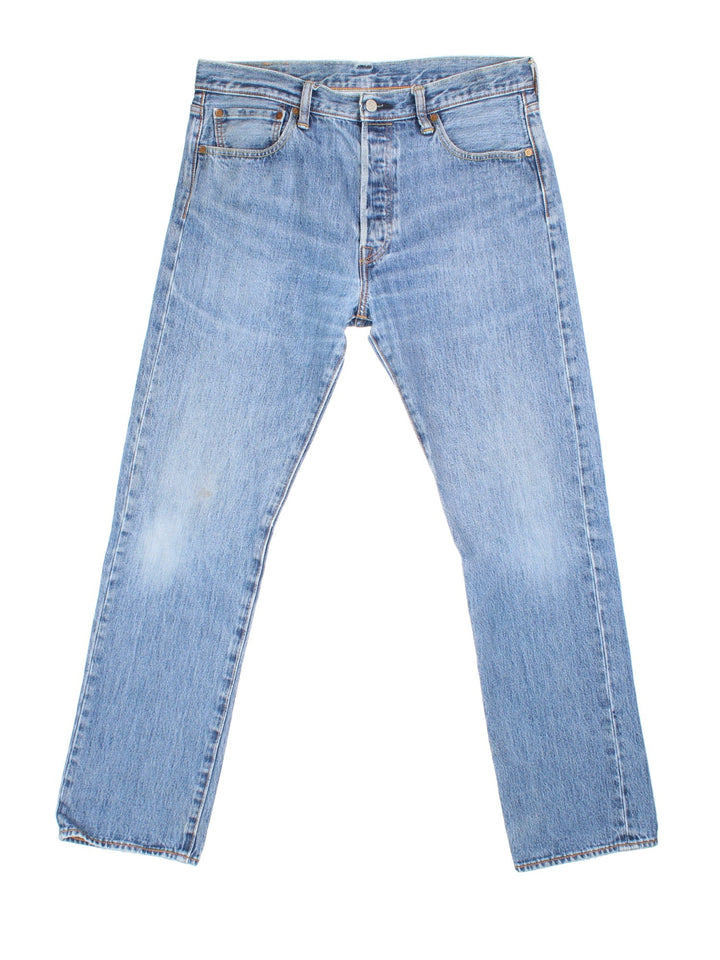 Levi Strauss 501 Jeans in blue colourway with multiple pockets and the logo tab embroidered on the back.