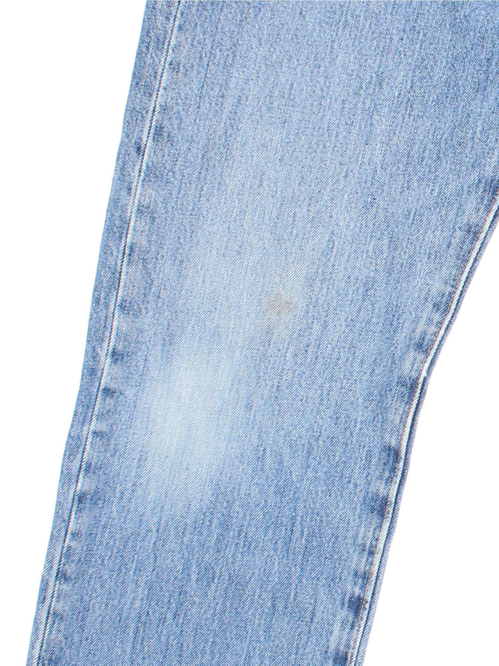 Levi Strauss 501 Jeans in blue colourway with multiple pockets and the logo tab embroidered on the back.