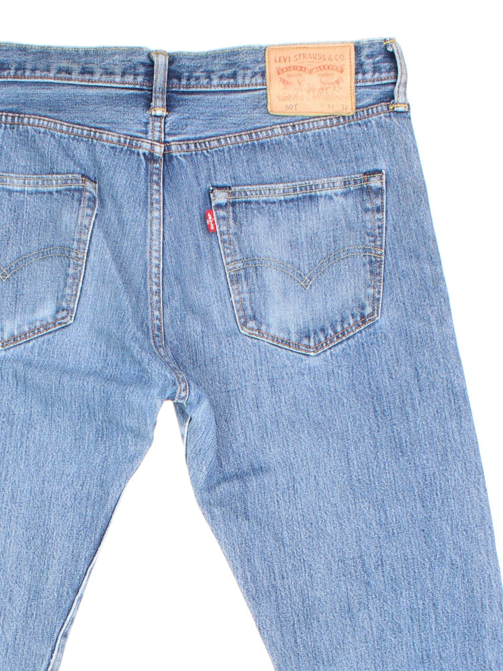 Levi Strauss 501 Jeans in blue colourway with multiple pockets and the logo tab embroidered on the back.