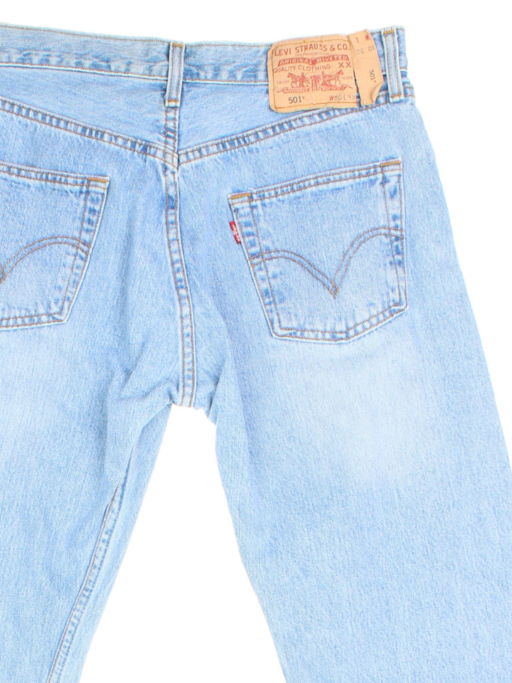 Levi Strauss 501 Jeans in blue colourway with multiple pockets and the logo tab embroidered on the back.