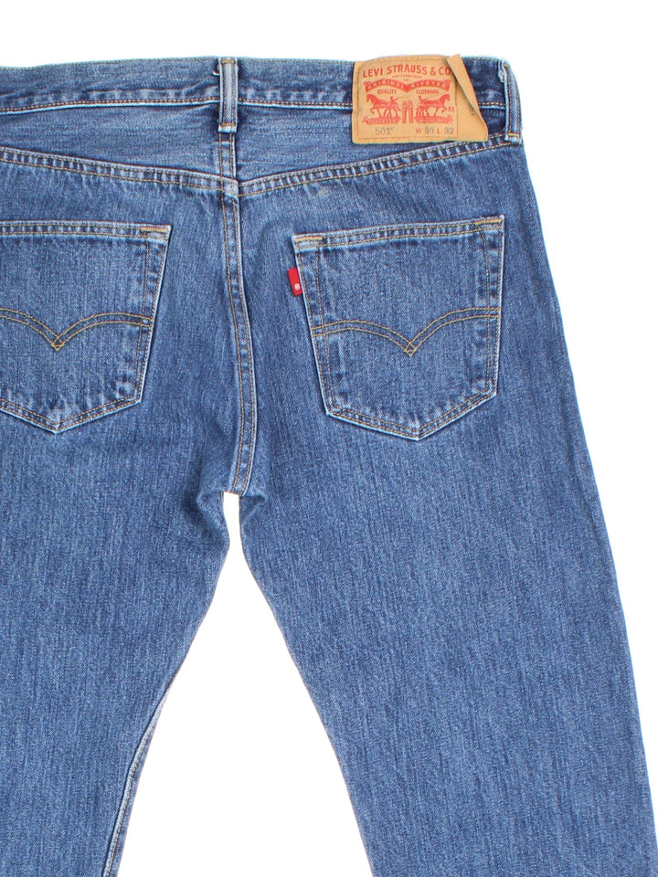 Levi Strauss 501 Jeans in blue colourway with multiple pockets and the logo tab embroidered on the back.