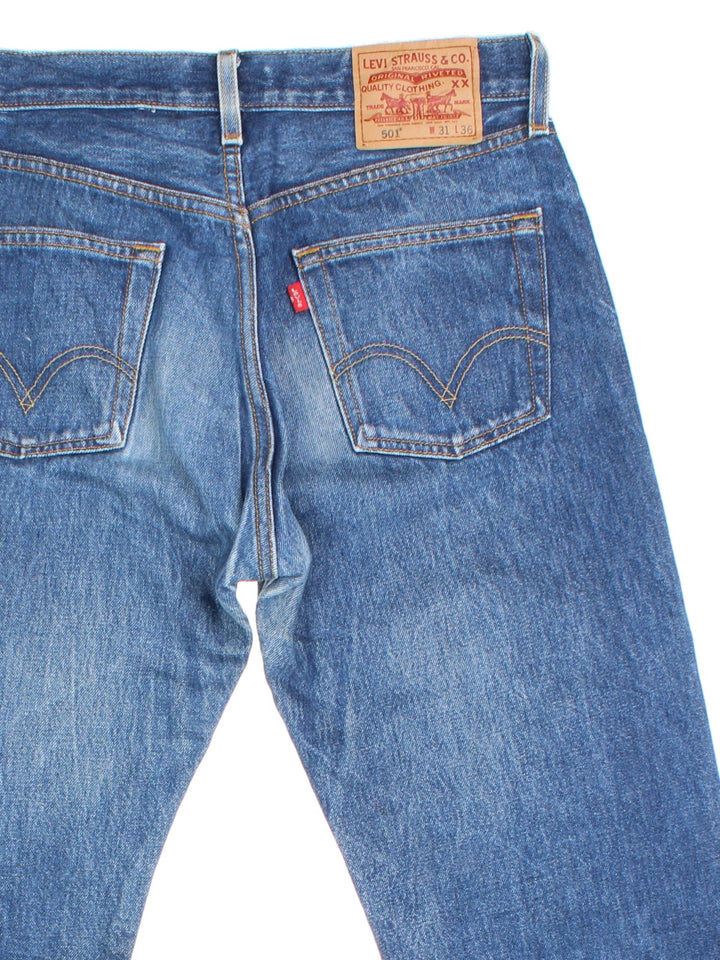 Levi Strauss 501 Jeans in blue colourway with multiple pockets and the logo tab embroidered on the back.