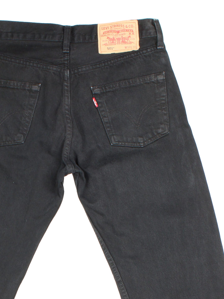 Levi Strauss 501 Jeans in black colourway with multiple pockets and the logo tab embroidered on the back.