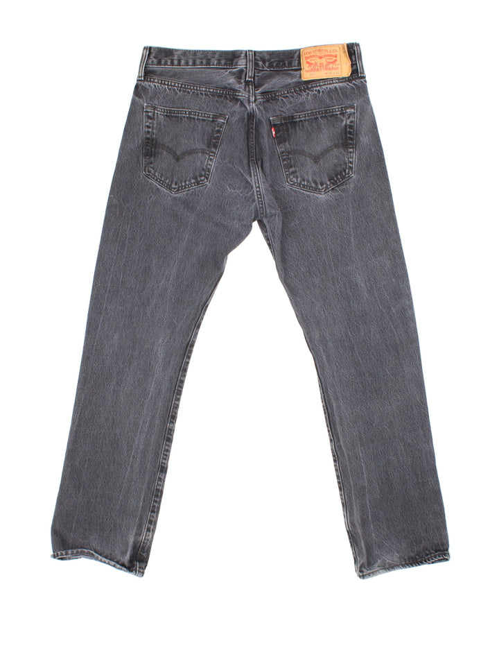 Levi Strauss 501 Jeans in grey colourway with multiple pockets and the logo tab embroidered on the back.