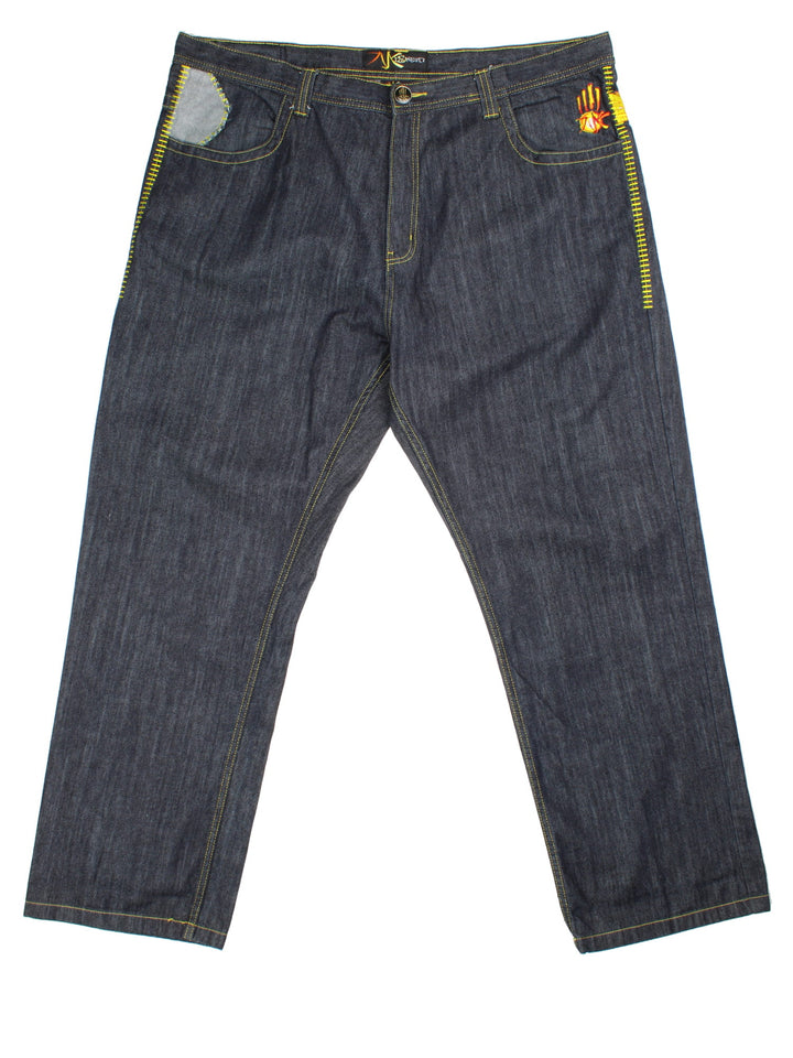 Y2K Miskeen Baggy Jeans in a dark blue colourway with multiple pockets, cross stitching details on the front and on the back has the logo embroidered alongside superhero characters on the pockets.