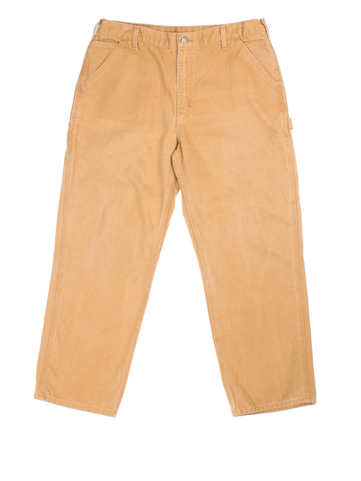 Carhartt Carpenter Jeans in tan colourway with multiple pockets and the logo embroidered on the back.