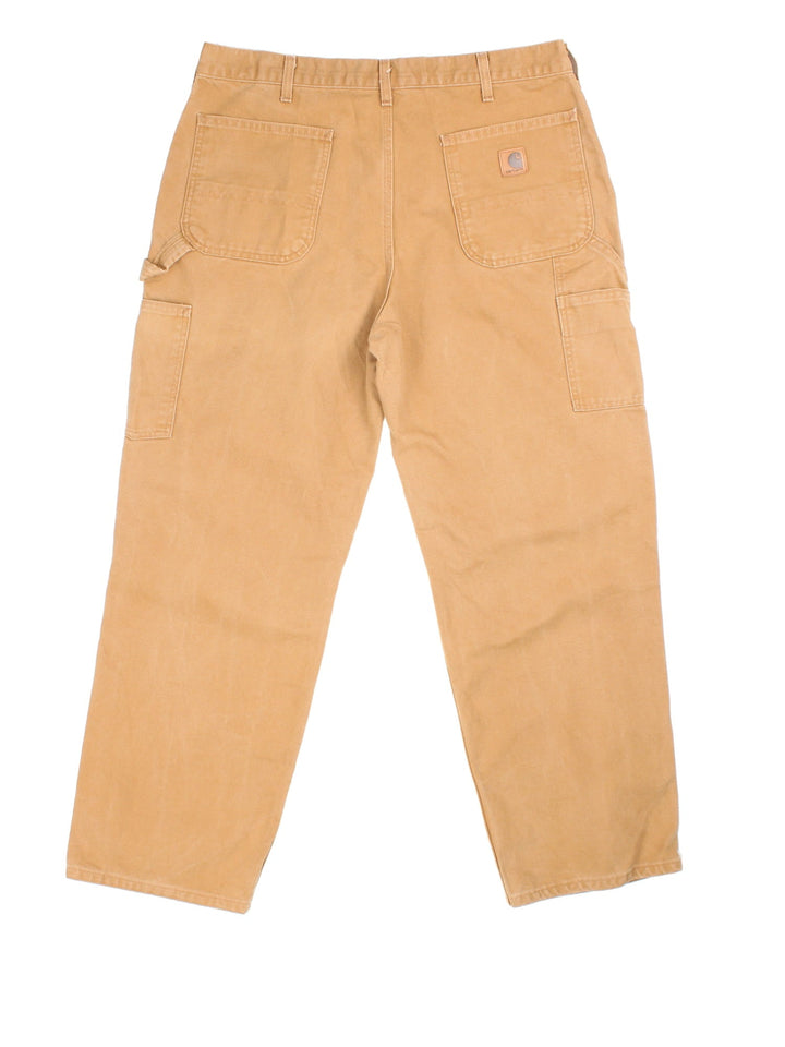 Carhartt Carpenter Jeans in tan colourway with multiple pockets and the logo embroidered on the back.