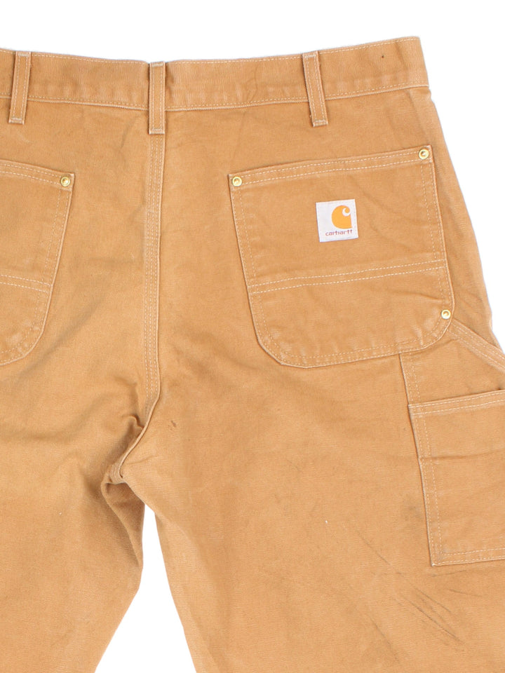 Carhartt Double Knee Jeans in tan colourway with multiple pockets and the logo embroidered on the back.