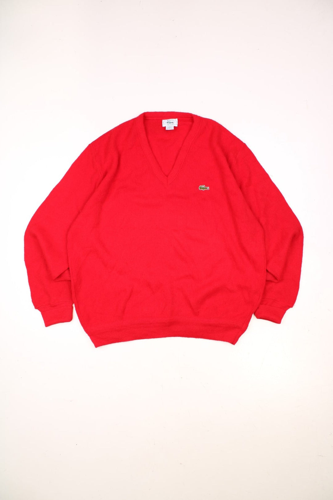 Vintage Izod Lacoste Knitted Jumper in a red colourway with a v neck and the logo embroidered on the front. 