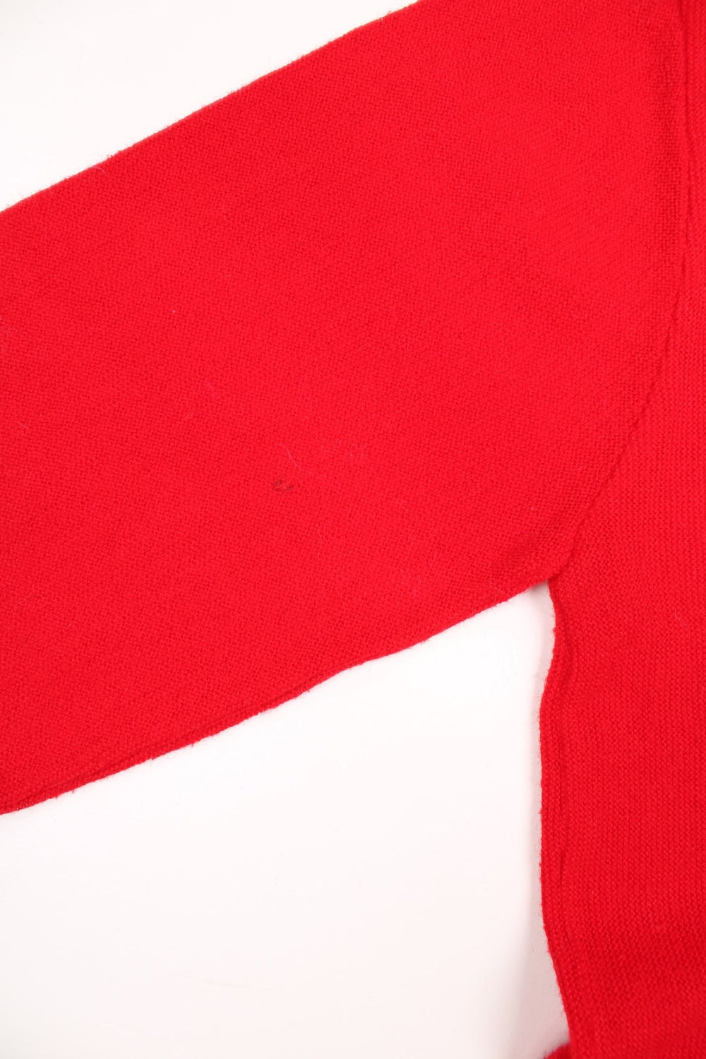 Vintage 70s Lacoste Izod knitted jumper in red. Features signature embroidered logo on the chest.