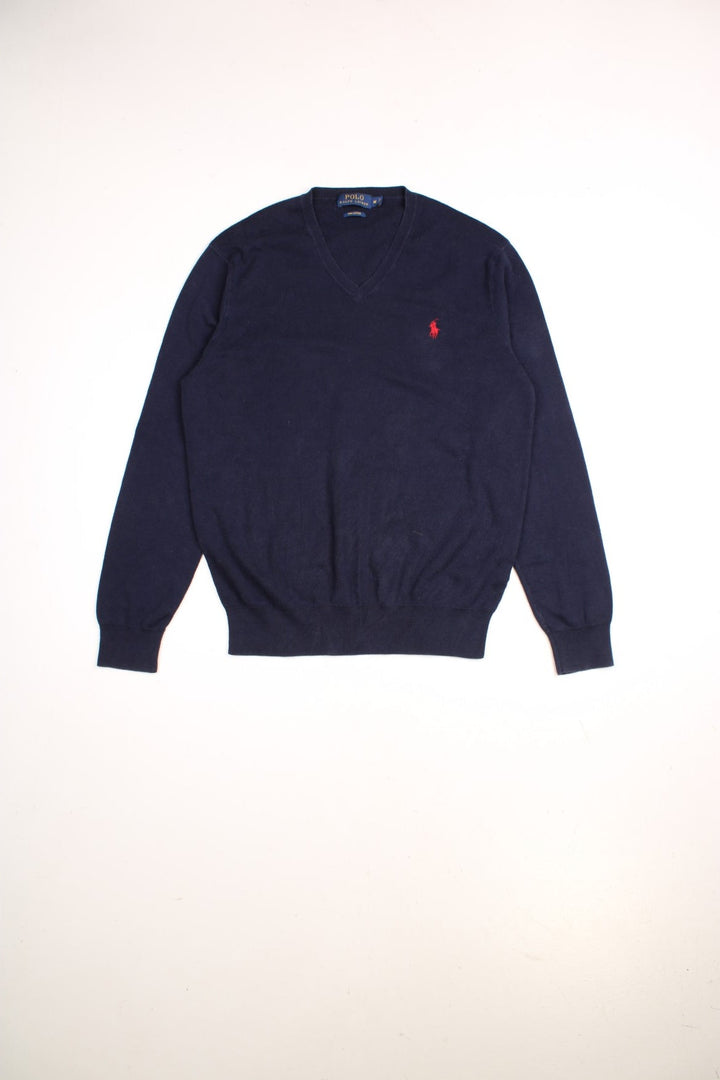 Ralph Lauren V neck jumper in a navy blue colourway with the traditional Ralph Lauren logo embroidered in red on the front.