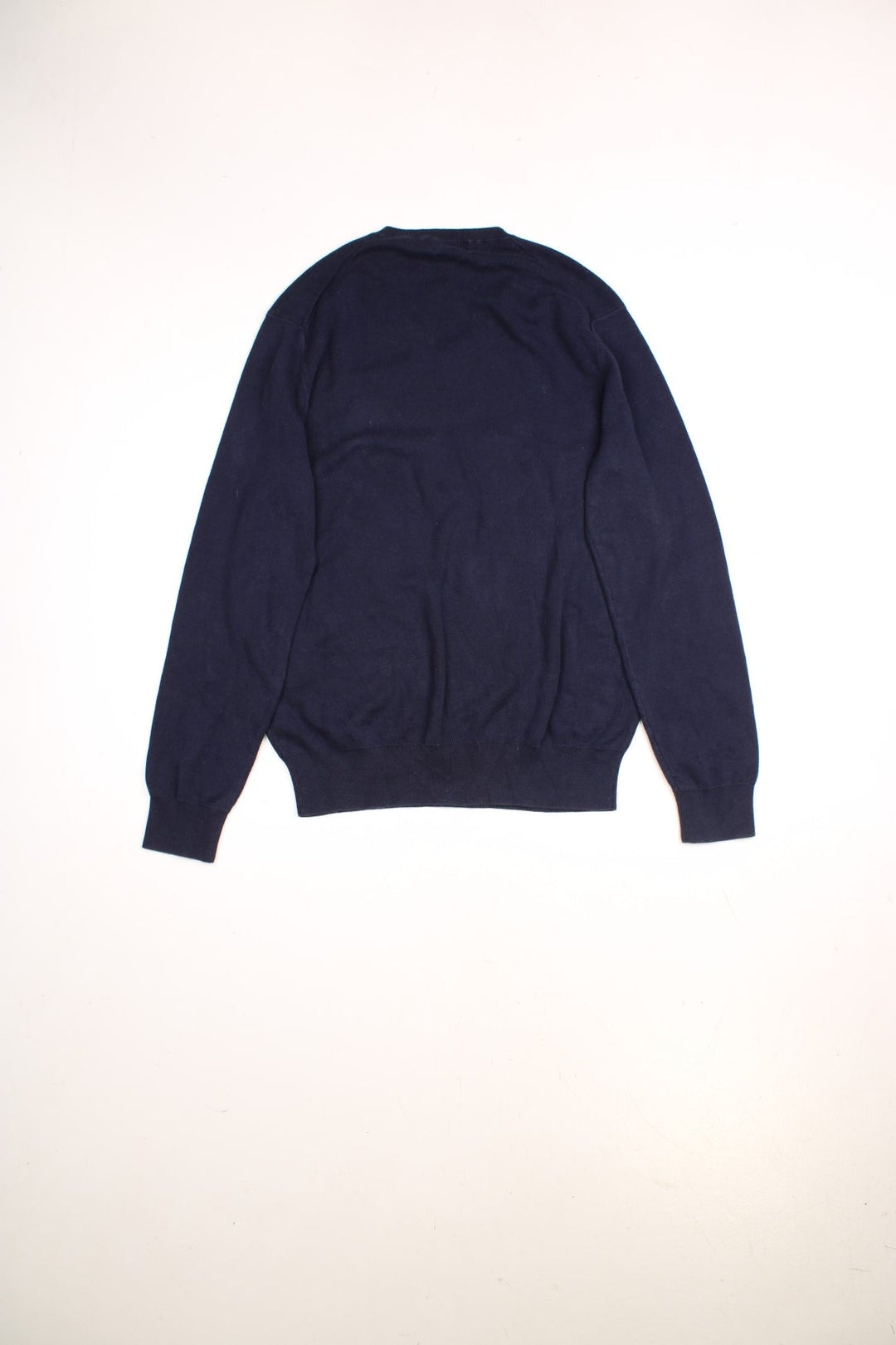 Ralph Lauren V neck jumper in a navy blue colourway with the traditional Ralph Lauren logo embroidered in red on the front.