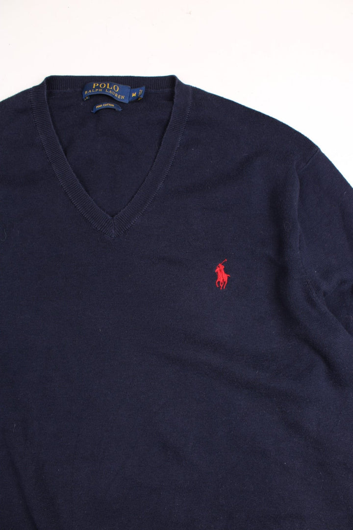 Ralph Lauren V neck jumper in a navy blue colourway with the traditional Ralph Lauren logo embroidered in red on the front.