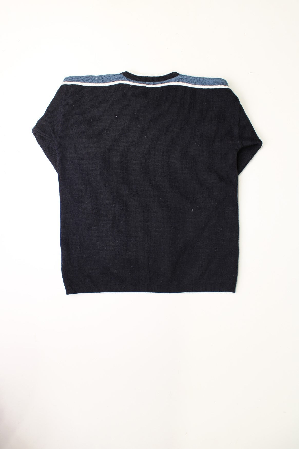 Kangol black knit v-neck jumper with blue and white stripe detail on the neck and shoulders.