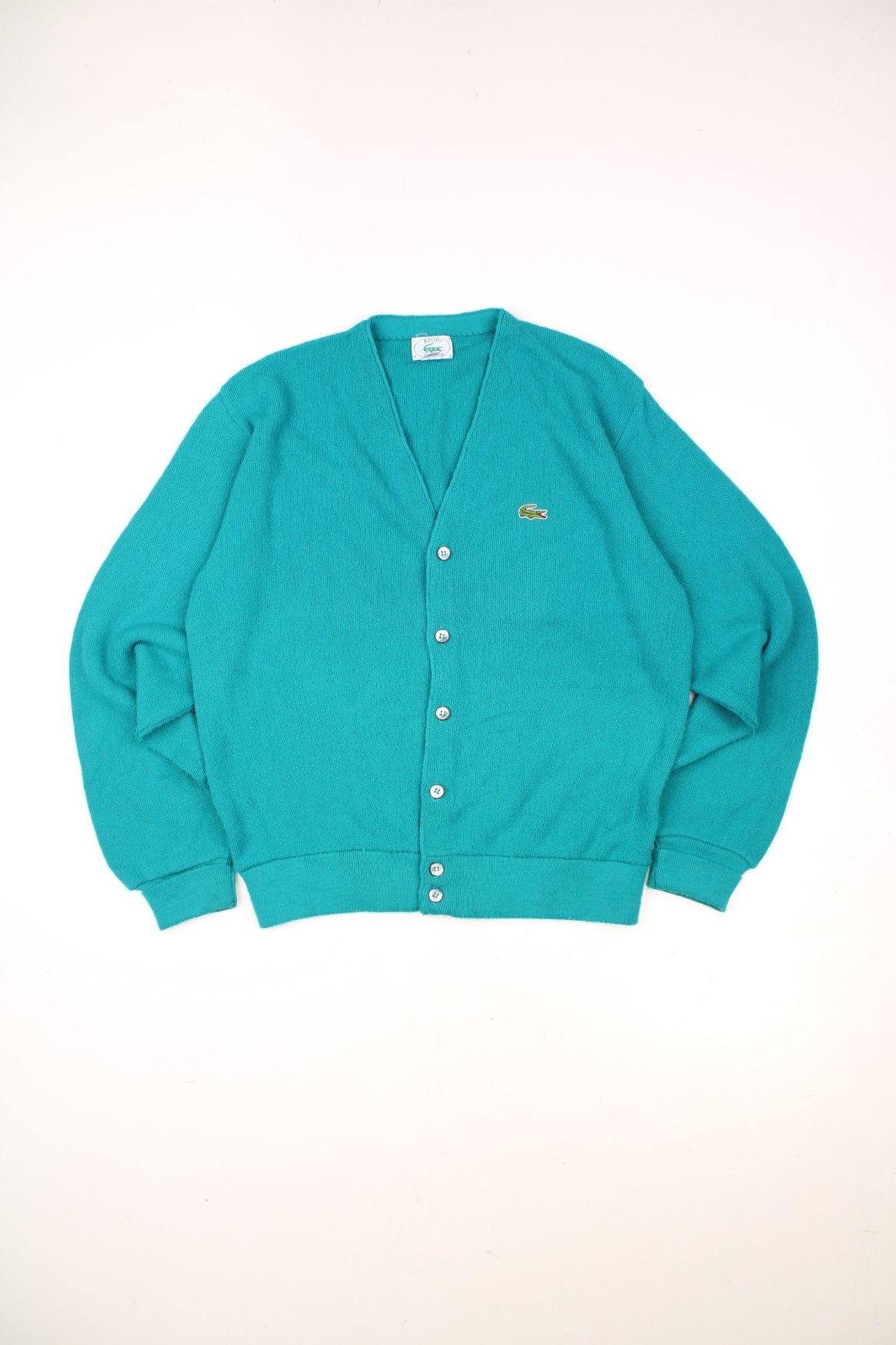 Izod Lacoste Cardigan in a turquoise colourway with the logo embroidered on the front and buttons up with a v neck collar. 