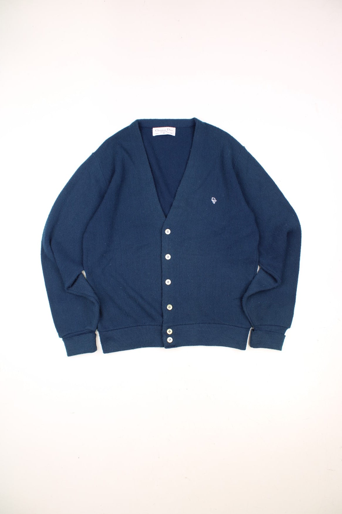 Vintage Christian Dior Knitted Cardigan in a navy blue colourway with the logo embroiderd on the chest and buttons up with a v neck collar. 