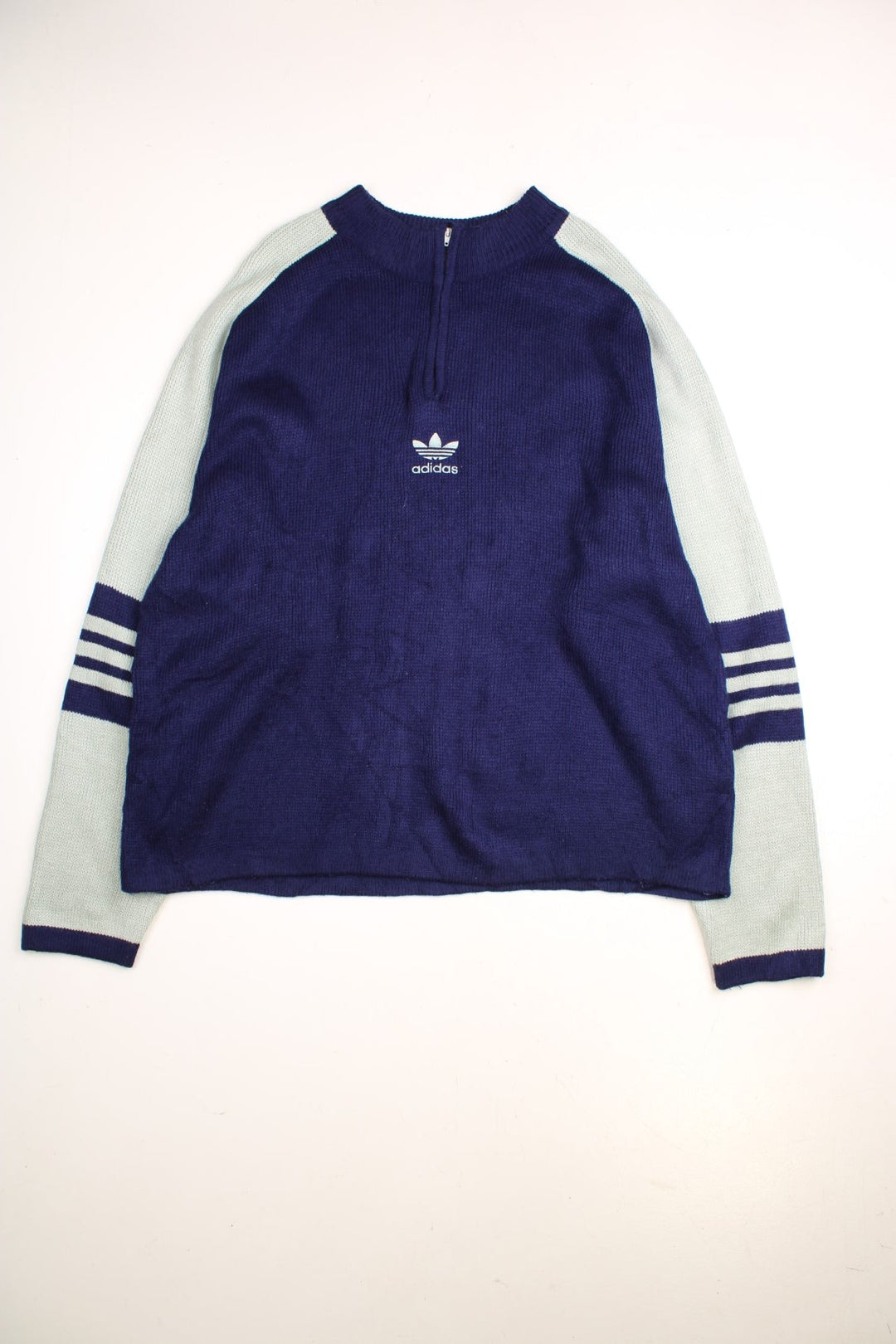 Adidas 1990s jumper in a navy blue and mint green colourway with stripes on the sleeves a 1/4 zip closure and Adidas logo embroidered on the front.