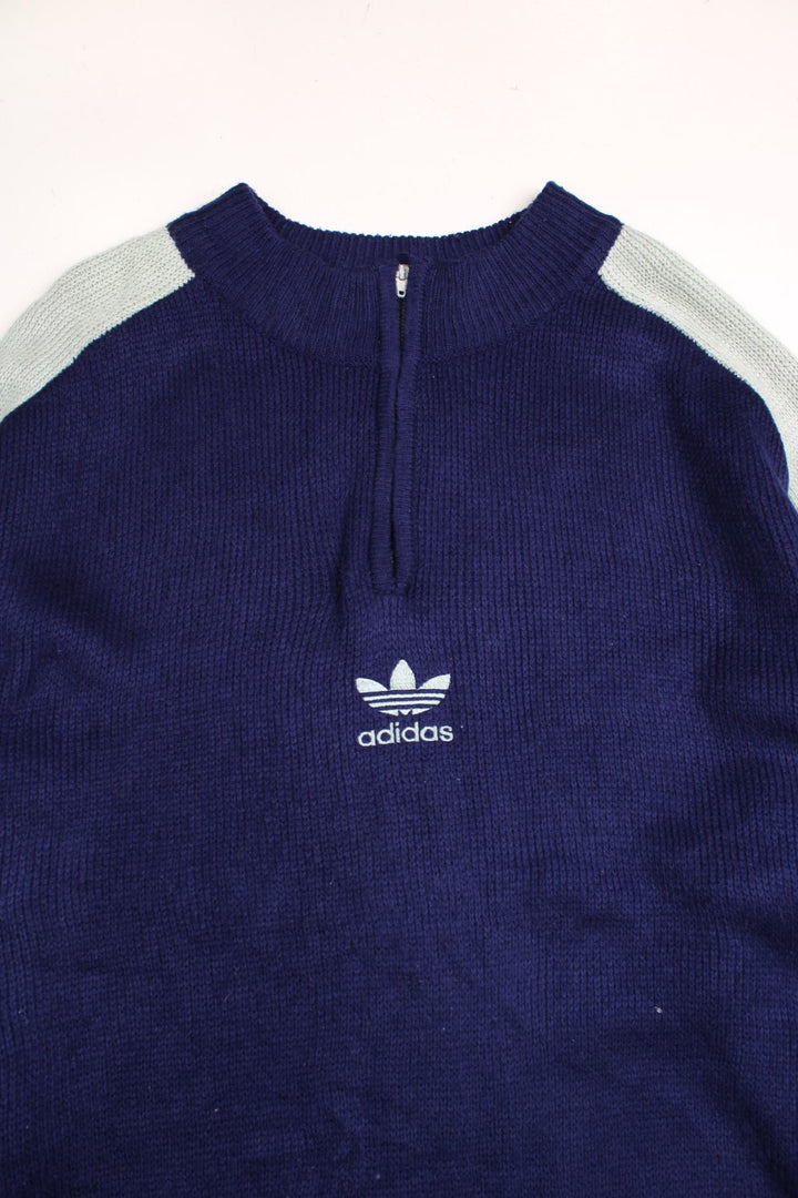 Adidas 1990s jumper in a navy blue and mint green colourway with stripes on the sleeves a 1/4 zip closure and Adidas logo embroidered on the front.