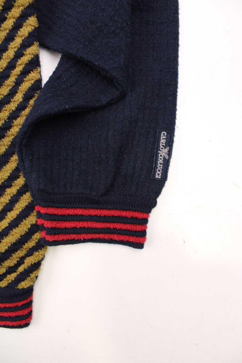 Vintage Carlo Colucci Patterned Jumper in a navy blue, red and yellow striped colourway with the logo embroidered on the left sleeve. 