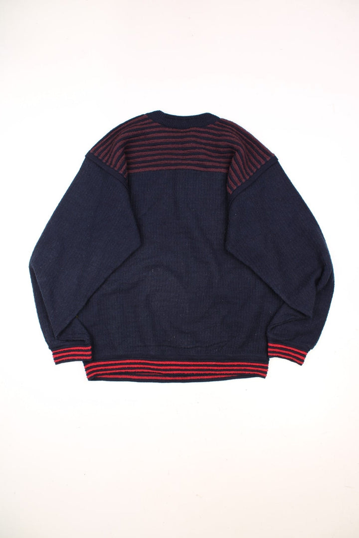 Vintage Carlo Colucci Patterned Jumper in a navy blue, red and yellow striped colourway with the logo embroidered on the left sleeve. 