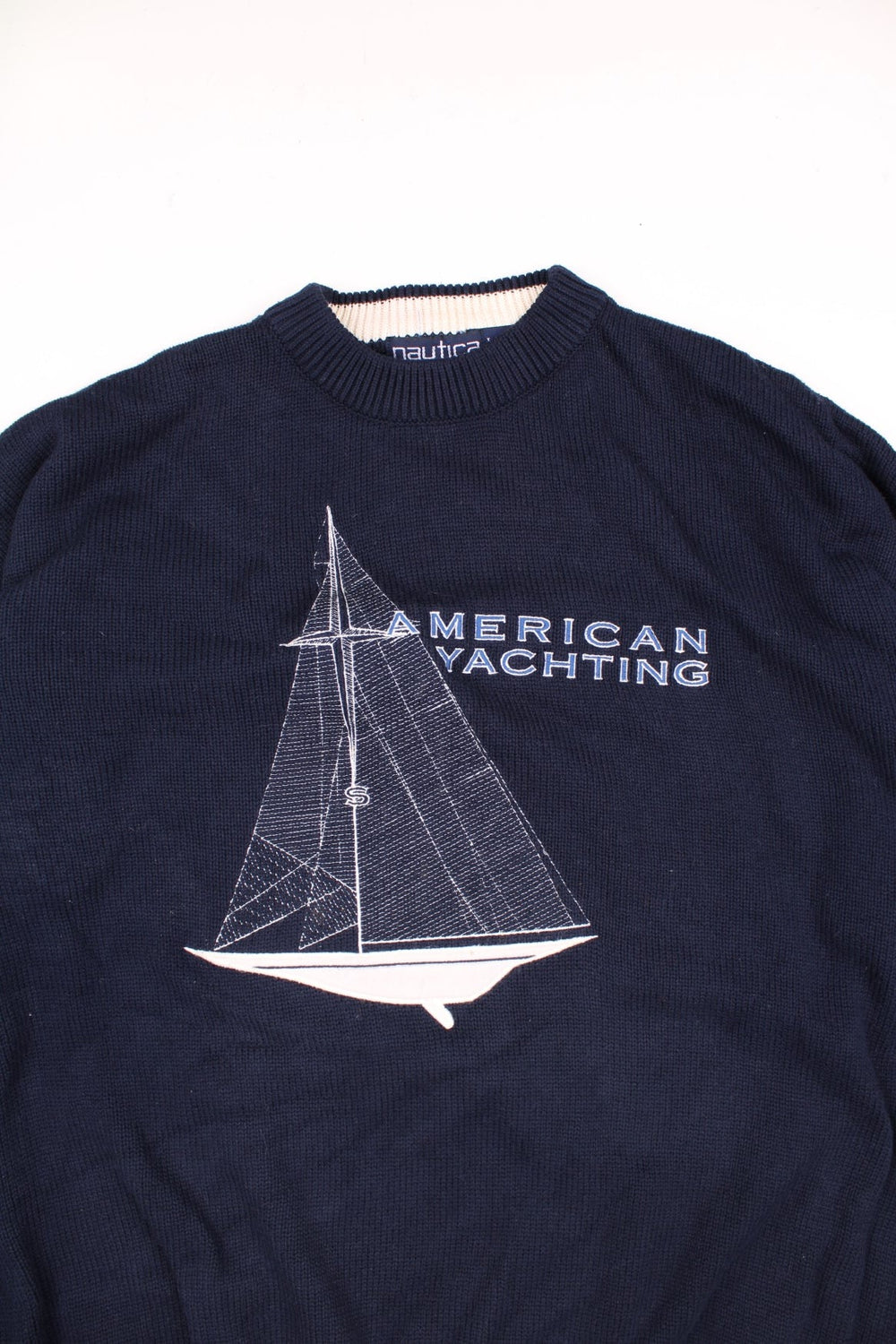 Nautica American Yachting Knitted Jumper in a navy blue and white colourway with the spell out logo and yatch graphic embroidered on the front. 